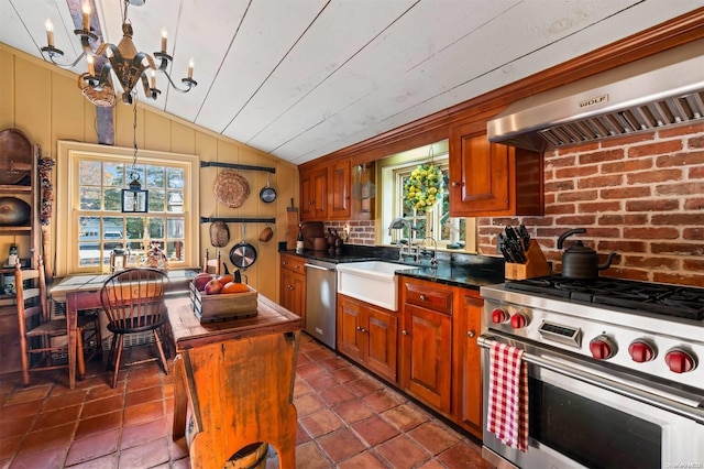 kitchen with appliances with stainless steel finishes, sink, pendant lighting, a center island, and range hood