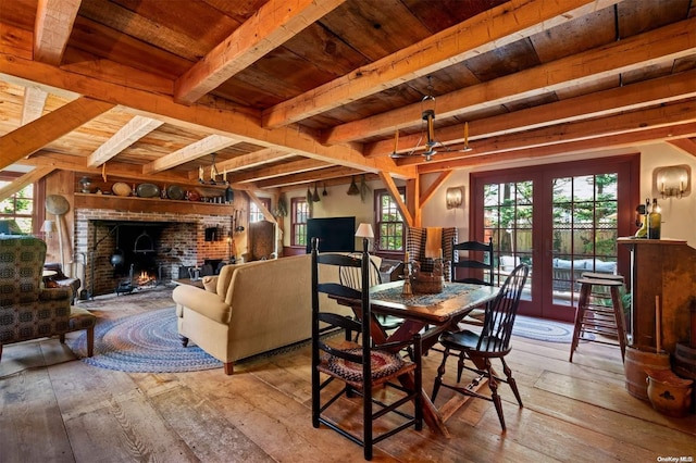 dining area featuring beam ceiling, light hardwood / wood-style floors, french doors, and wooden ceiling