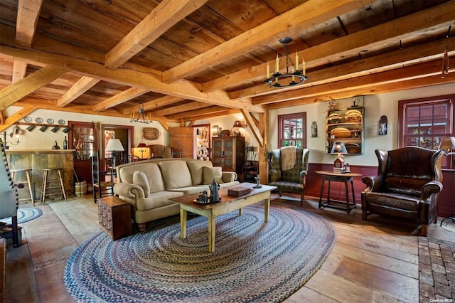 living room featuring wooden ceiling, beamed ceiling, wood-type flooring, and a notable chandelier