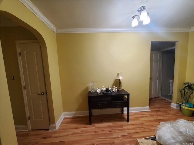 hall featuring crown molding and light wood-type flooring