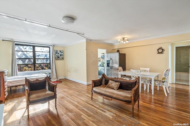 living room with hardwood / wood-style floors and ornamental molding