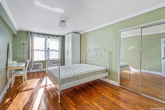 bedroom with hardwood / wood-style floors, a closet, and ornamental molding