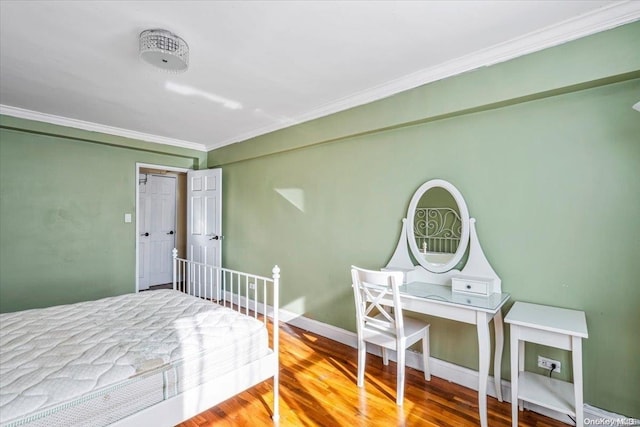 bedroom featuring hardwood / wood-style floors and ornamental molding