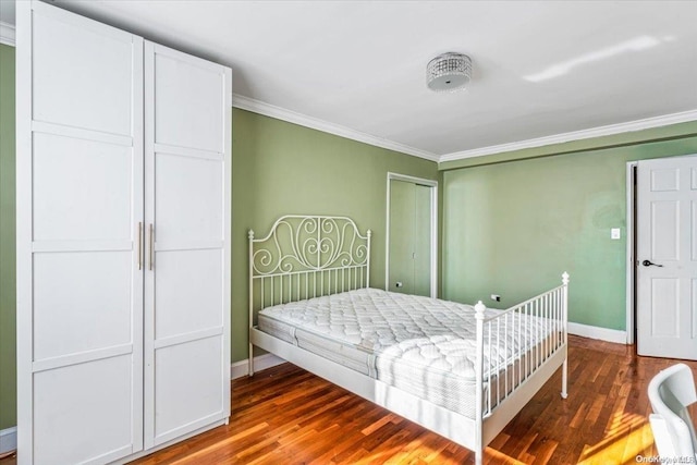 bedroom with crown molding and dark hardwood / wood-style flooring