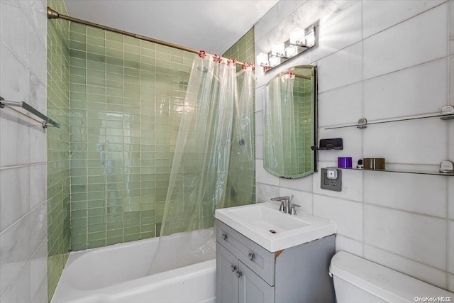 full bathroom featuring vanity, toilet, shower / bathtub combination with curtain, and tile walls