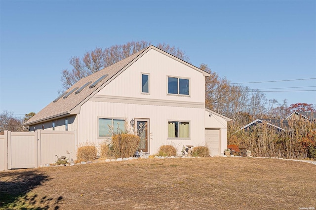 view of front of home with a garage and a front lawn