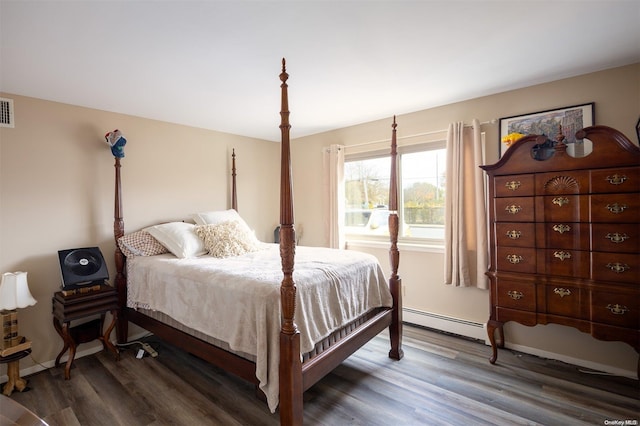 bedroom featuring baseboard heating and dark hardwood / wood-style floors