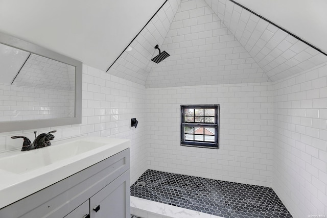 bathroom featuring vanity and tiled shower