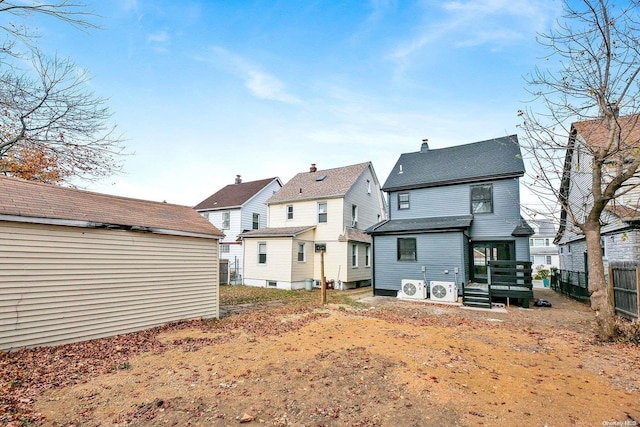 rear view of property with ac unit and a wooden deck