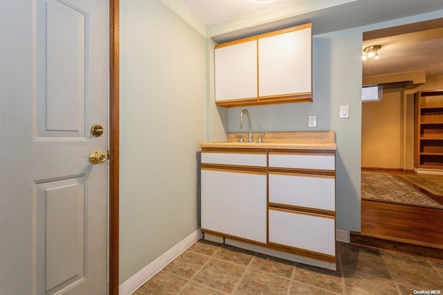 interior space featuring white cabinetry, sink, and hardwood / wood-style floors