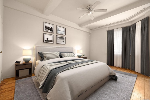 bedroom with ceiling fan, beamed ceiling, and wood-type flooring