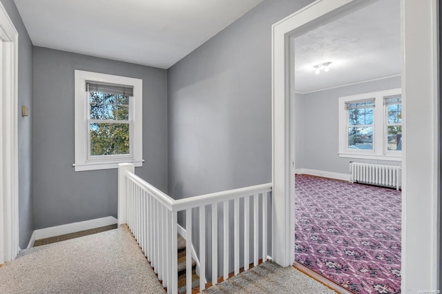 hall with light carpet and radiator heating unit