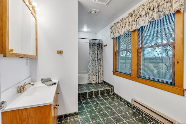 bathroom with baseboard heating and vanity