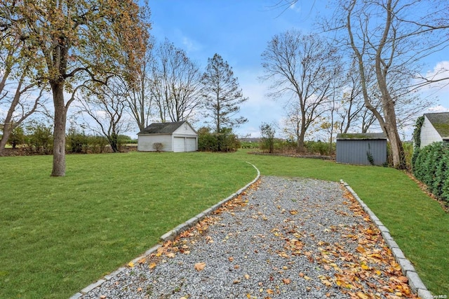 view of yard with a garage and an outdoor structure