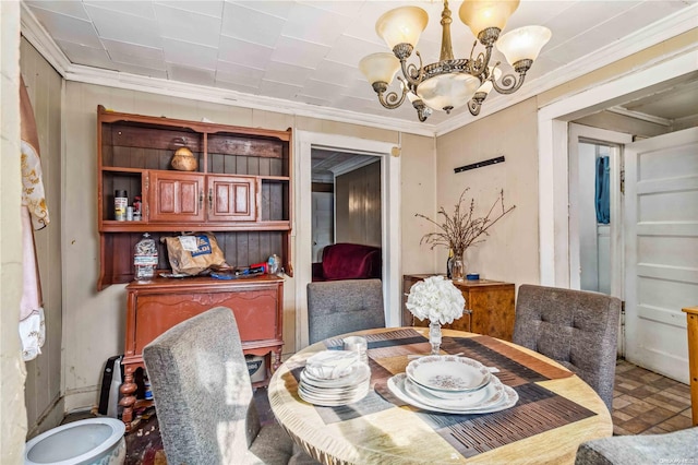 dining area with ornamental molding and a notable chandelier