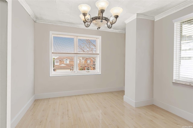 empty room with ornamental molding, light hardwood / wood-style floors, and a notable chandelier