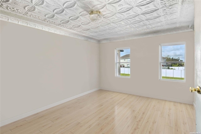 unfurnished room featuring light hardwood / wood-style flooring and a healthy amount of sunlight