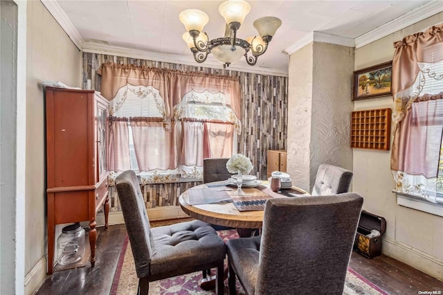 dining area featuring dark hardwood / wood-style flooring, crown molding, and an inviting chandelier