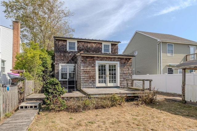 back of house with a yard and a wooden deck