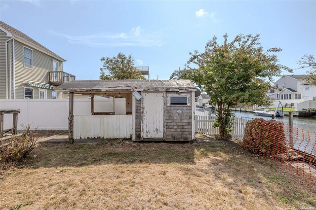 view of yard with a water view and a storage shed