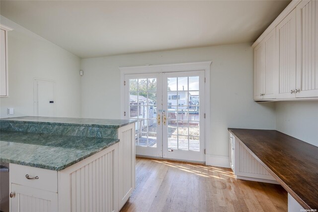 kitchen featuring white cabinets, french doors, and light hardwood / wood-style flooring