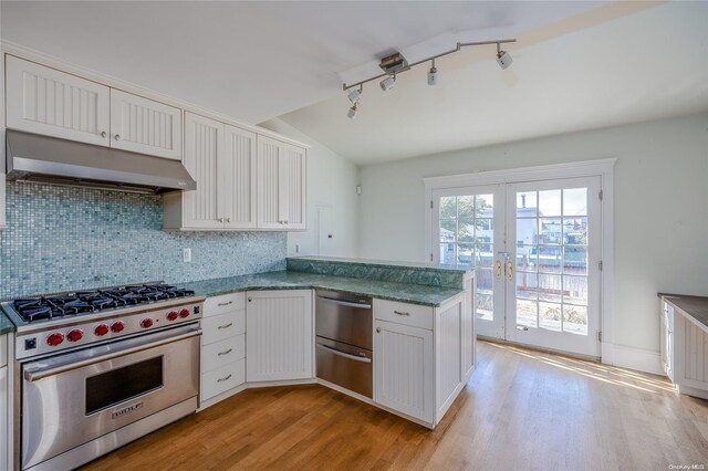 kitchen featuring french doors, white cabinetry, light wood-type flooring, premium stove, and kitchen peninsula