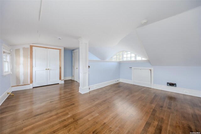 additional living space featuring hardwood / wood-style flooring and vaulted ceiling