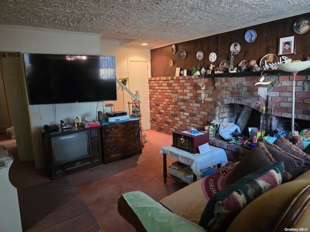 206 W Marshall St, Hempstead, NY 11550 - carpeted living room featuring a textured ceiling and wood walls