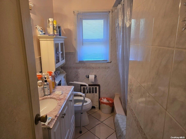 206 W Marshall St, Hempstead, NY 11550 - full bathroom with tile patterned floors, toilet, tile walls, radiator, and vanity