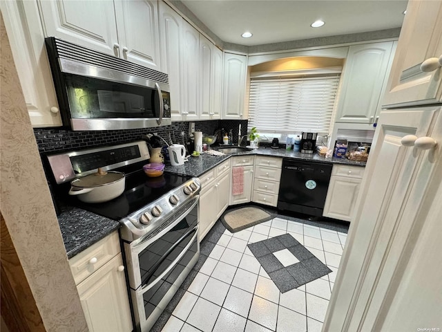 kitchen featuring light tile patterned floors, white cabinets, appliances with stainless steel finishes, and tasteful backsplash