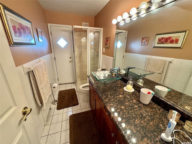 bathroom featuring vanity, walk in shower, tile patterned floors, and toilet