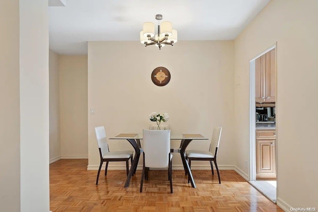 dining area with light parquet flooring and an inviting chandelier