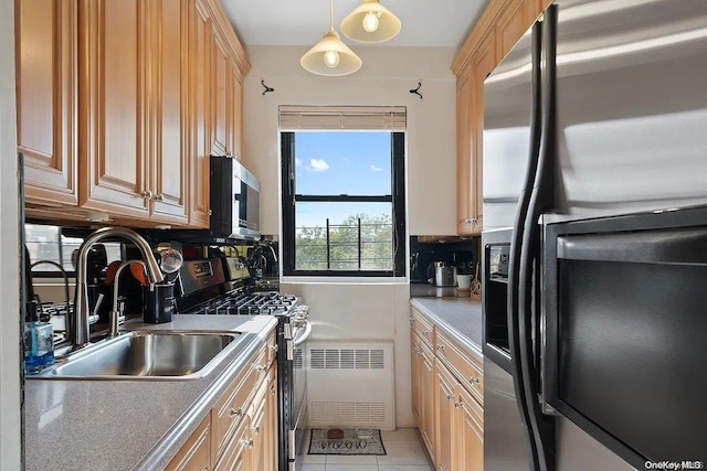 kitchen with stainless steel appliances, sink, light brown cabinets, hanging light fixtures, and light tile patterned flooring