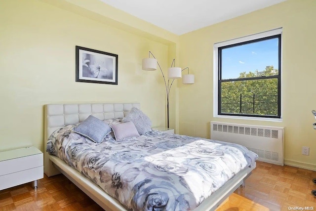 bedroom with parquet flooring and radiator heating unit