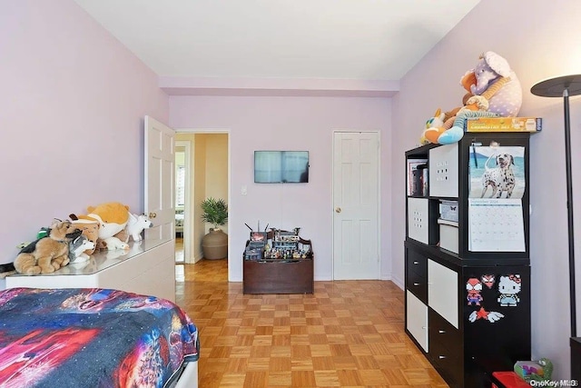 bedroom with light parquet flooring