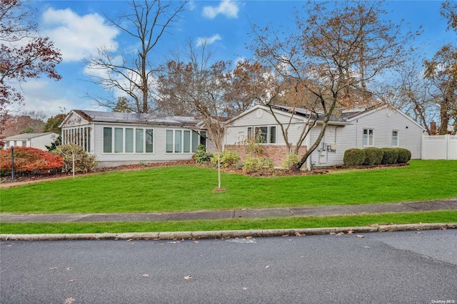 ranch-style house with a front lawn