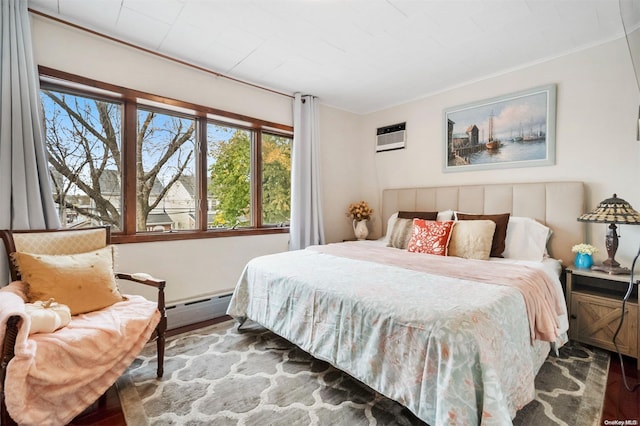 bedroom with baseboard heating, wood-type flooring, and a wall mounted air conditioner