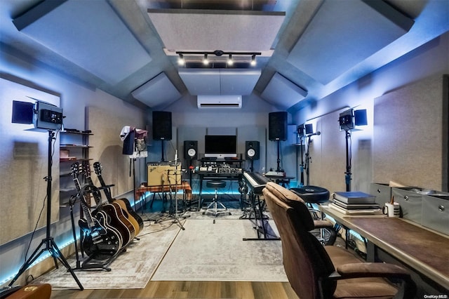 home office with vaulted ceiling, track lighting, light hardwood / wood-style flooring, and a wall mounted AC