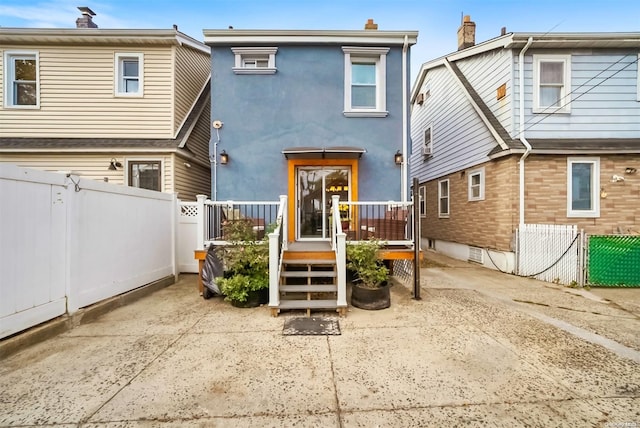 back of property with a wooden deck