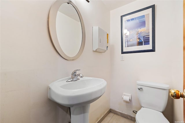 bathroom with sink, tile patterned flooring, and toilet