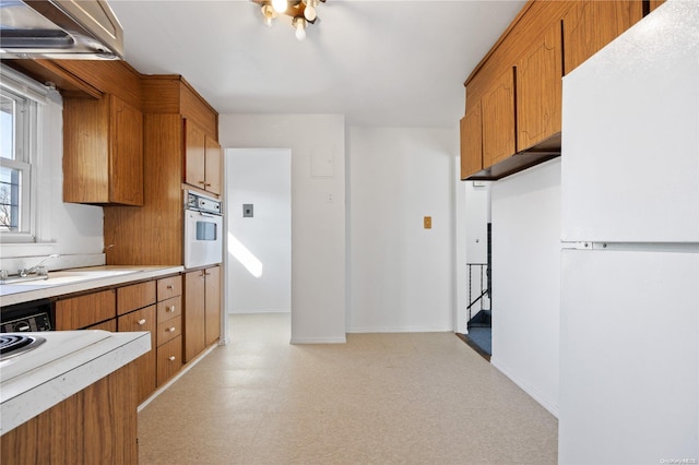 kitchen featuring white appliances and sink