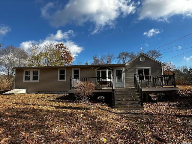 rear view of property with a wooden deck