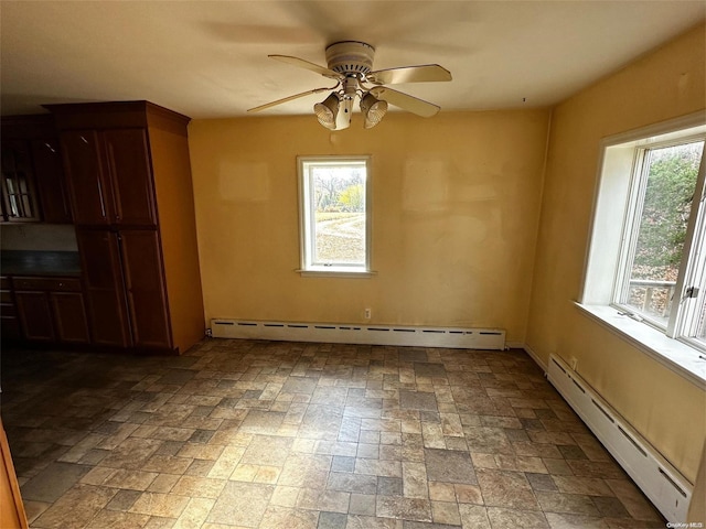 unfurnished room featuring ceiling fan and baseboard heating