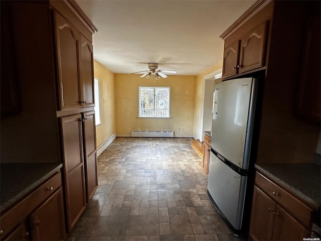 kitchen with baseboard heating, stainless steel fridge, and ceiling fan