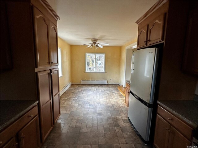 2468 River Rd, Calverton, NY 11933 - kitchen featuring freestanding refrigerator, dark countertops, a ceiling fan, and a baseboard radiator