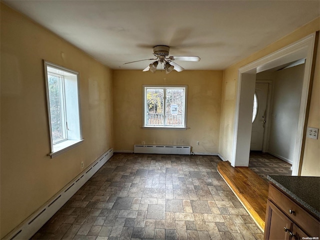 unfurnished room featuring hardwood / wood-style flooring, ceiling fan, and baseboard heating