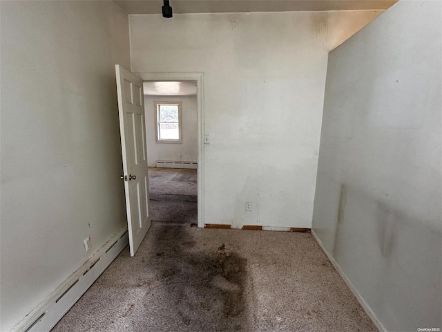 interior space with carpet and a baseboard heating unit