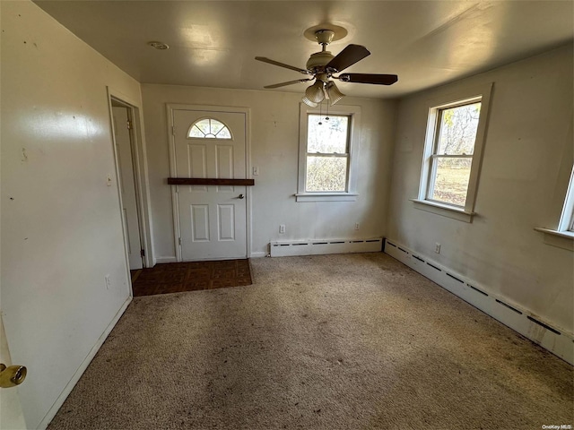 entrance foyer with carpet, ceiling fan, and a baseboard heating unit