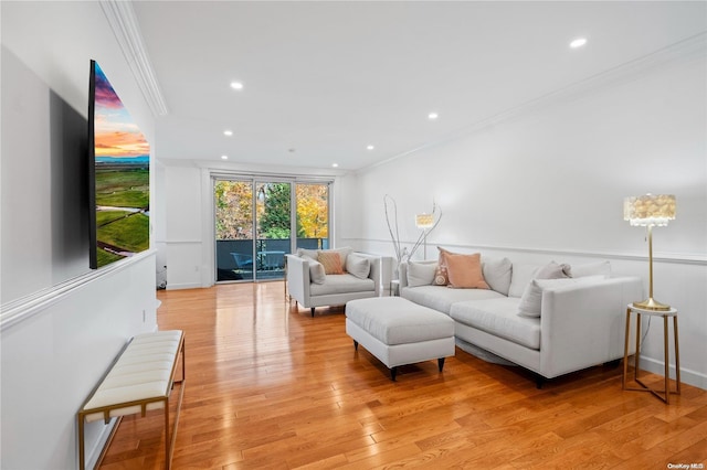 living room with light hardwood / wood-style flooring and crown molding