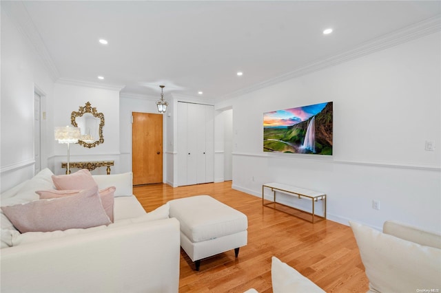 living room featuring wood-type flooring and ornamental molding